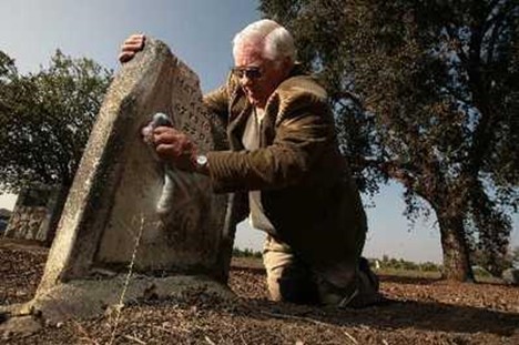 Bill Coate cleaning a headstone
